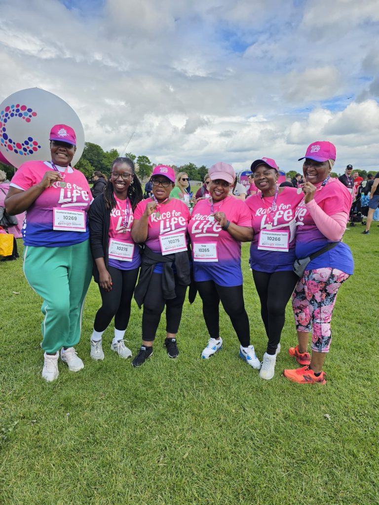 Members of the Scotland Charge celebrate completing the 2025 Race for Life, proudly displaying their medals after walking together to support cancer research and families affected by the disease. Photo courtesy of UK District RRW Sports and Recreation.